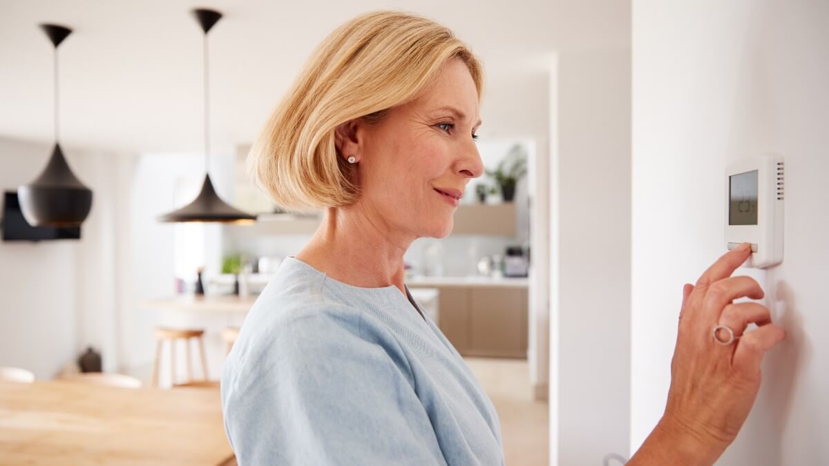 Woman Checking Thermostat