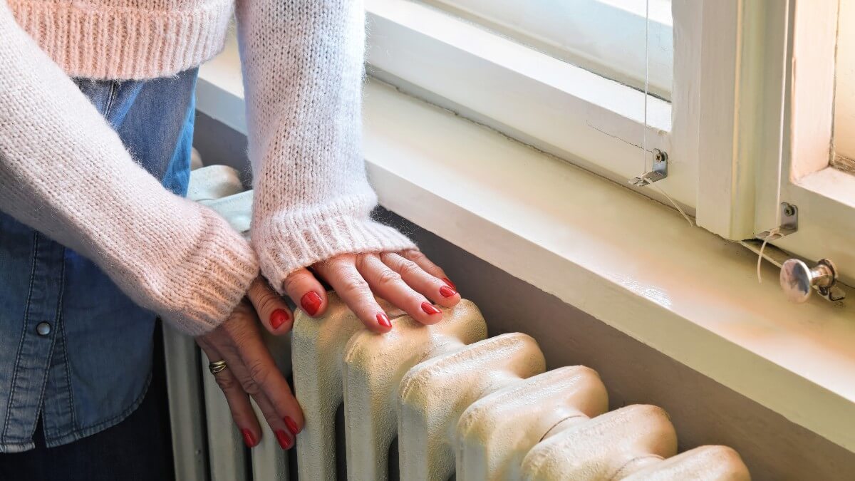 Woman With Hands On Radiator